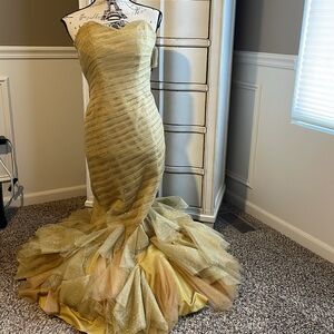 Gold strapless mermaid-style formal gown with a ruffled tulle skirting